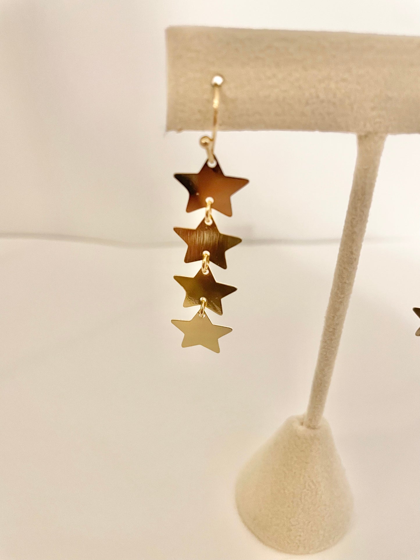 Dangly gold star earrings